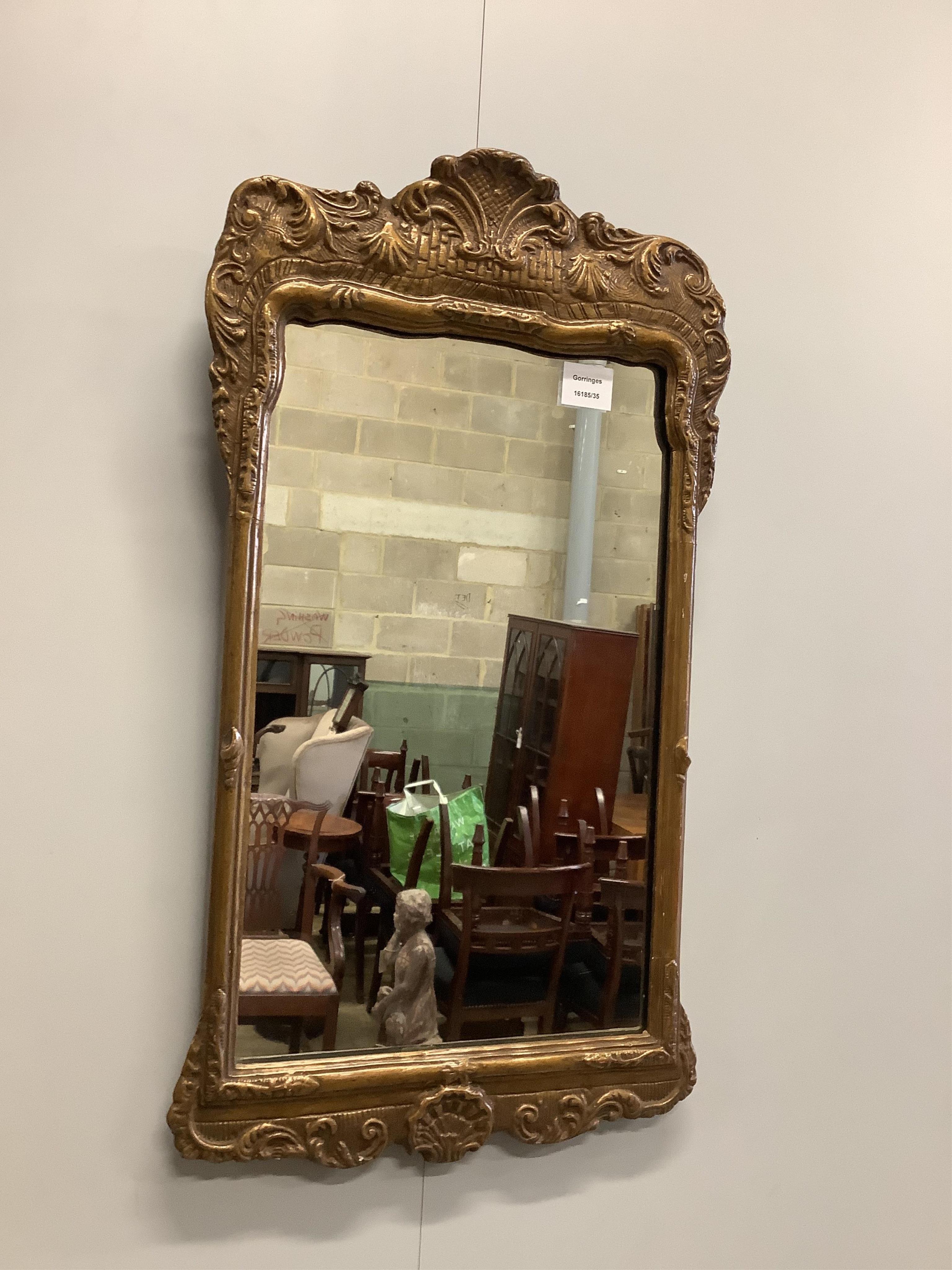 A George I style gilt wall mirror, width 39cm, height 70cm. Condition - fair